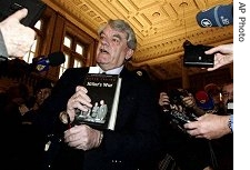 British historian David Irving holds his book "Hitler's War" when arriving at a court in Vienna, on Monday, Feb. 20, 2006. Irving is accused of denying the Holocaust and is facing up to 10 years in jail